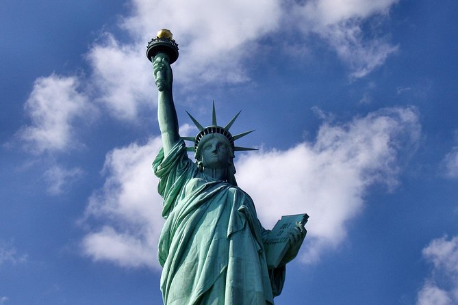 Statue of Liberty & Pre-Ferry Express Tour - Ellis Island: Wall of Heroes, Great Hall, and time that still flies